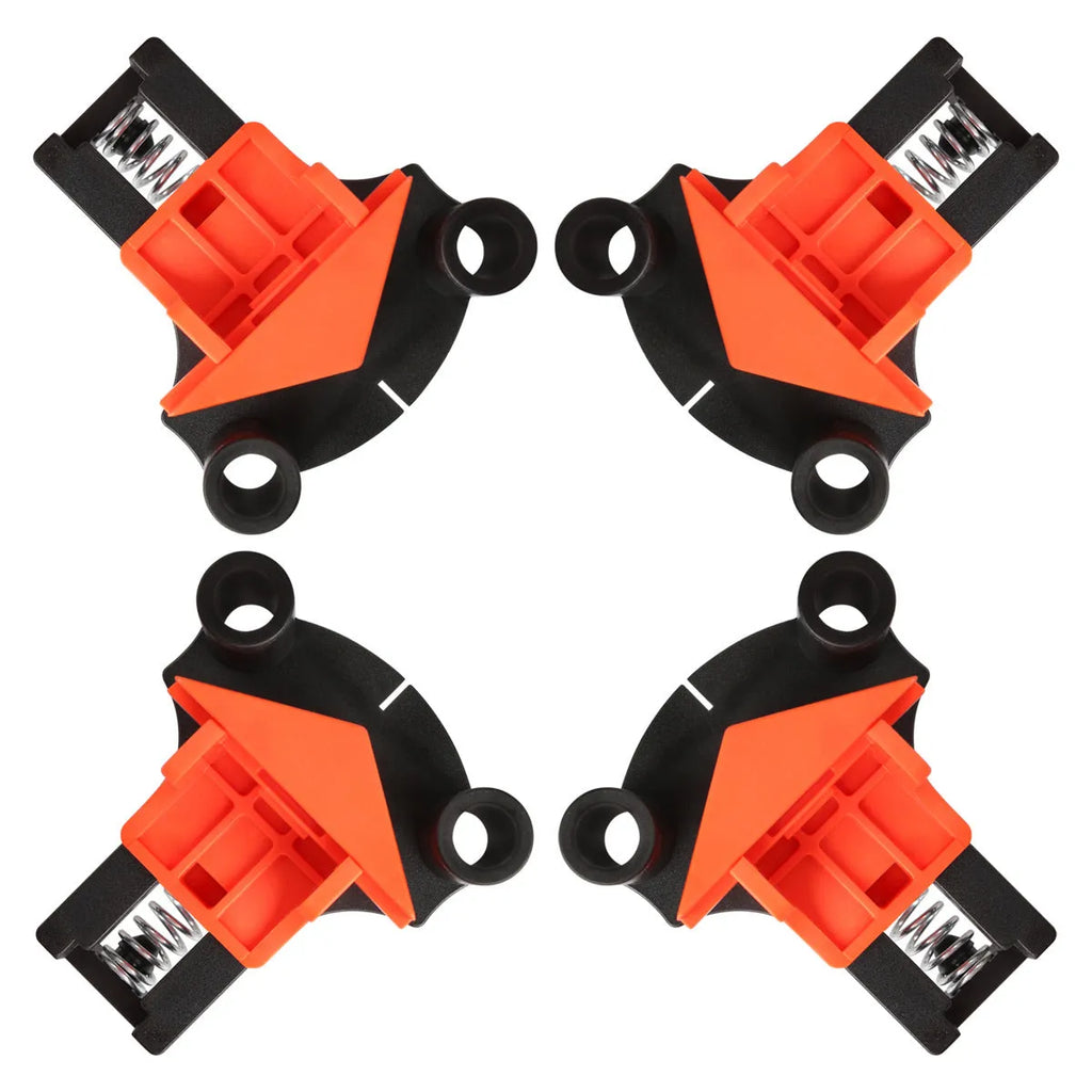 Set of four white plastic 90-degree right-angle clamps for picture frames on a workbench.