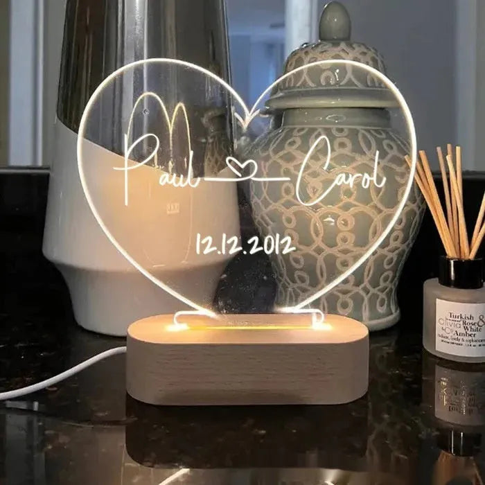 Custom transparent acrylic LED night light etched with personal names and date.
