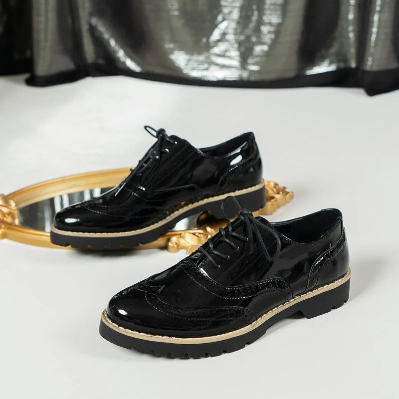 Women's black lace-up loafers with mirror sequins and a wedge heel, shown from the side.