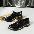 Women's black lace-up loafers with mirror sequins and a wedge heel, shown from the side.