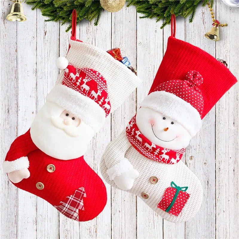 Large red and white knitted Christmas stocking with Santa Claus design hanging on a fireplace.