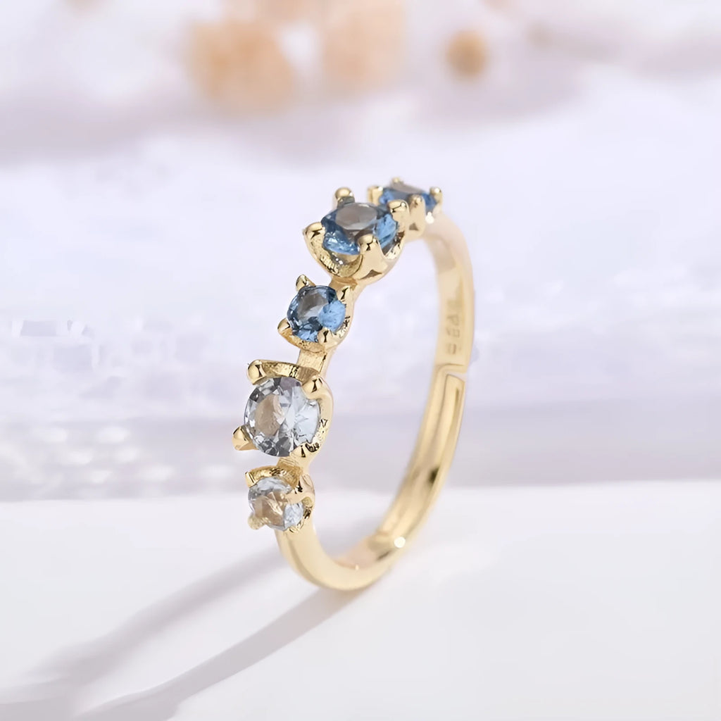 Gradient blue and white topaz multi-gemstone zircon ring with adjustable open mouth design