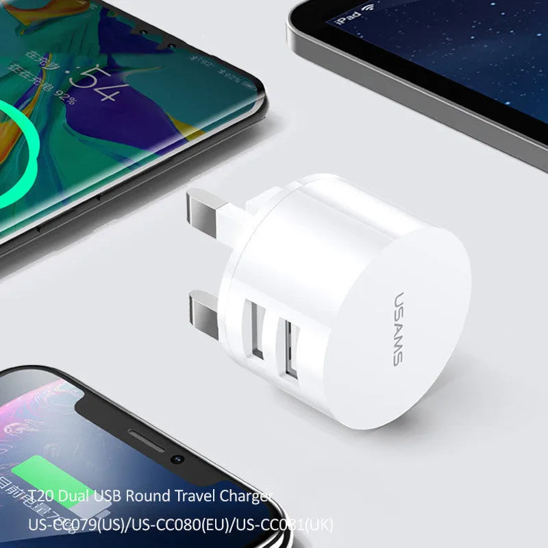 White portable dual USB charger with folding UK, US, and EU plugs showing compact dimensions