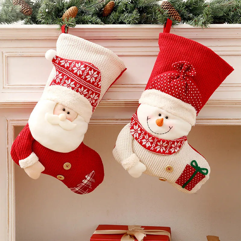 Large red and white knitted Christmas stocking with Santa Claus design hanging on a fireplace.