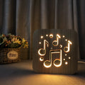 Square pine wood USB-powered LED lamp emitting warm white 3D light on a table.