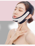 Pink and black elastic V-shaped face bandage facial care tool on a white background.