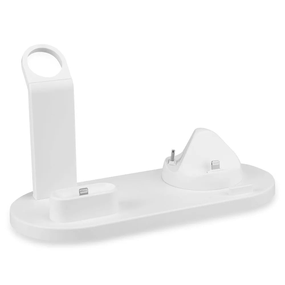 White headphone charging stand with dual USB ports on a wooden desk next to wireless headphones.