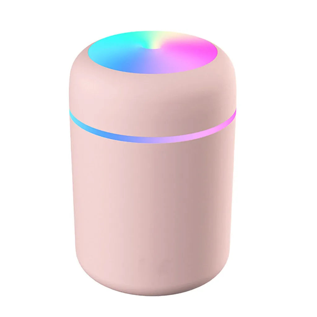 Mini ultrasonic essential oil diffuser with 300ml water tank in white, showing coloured night lights and USB cable