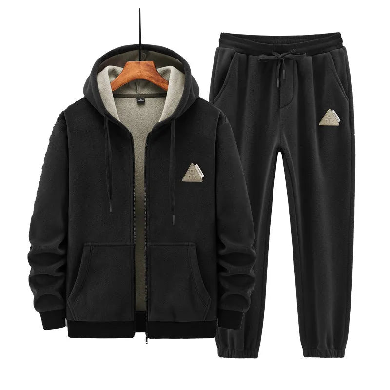 A grey men's casual sports suit featuring a hooded sweater and matching trousers on a hanger.