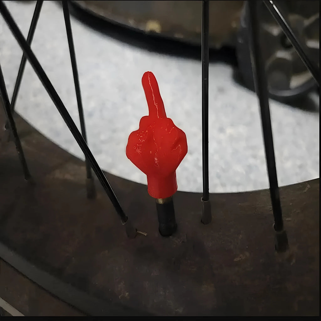 Four latex tyre valve dust caps, two black and two skin colour, for car tyre protection.
