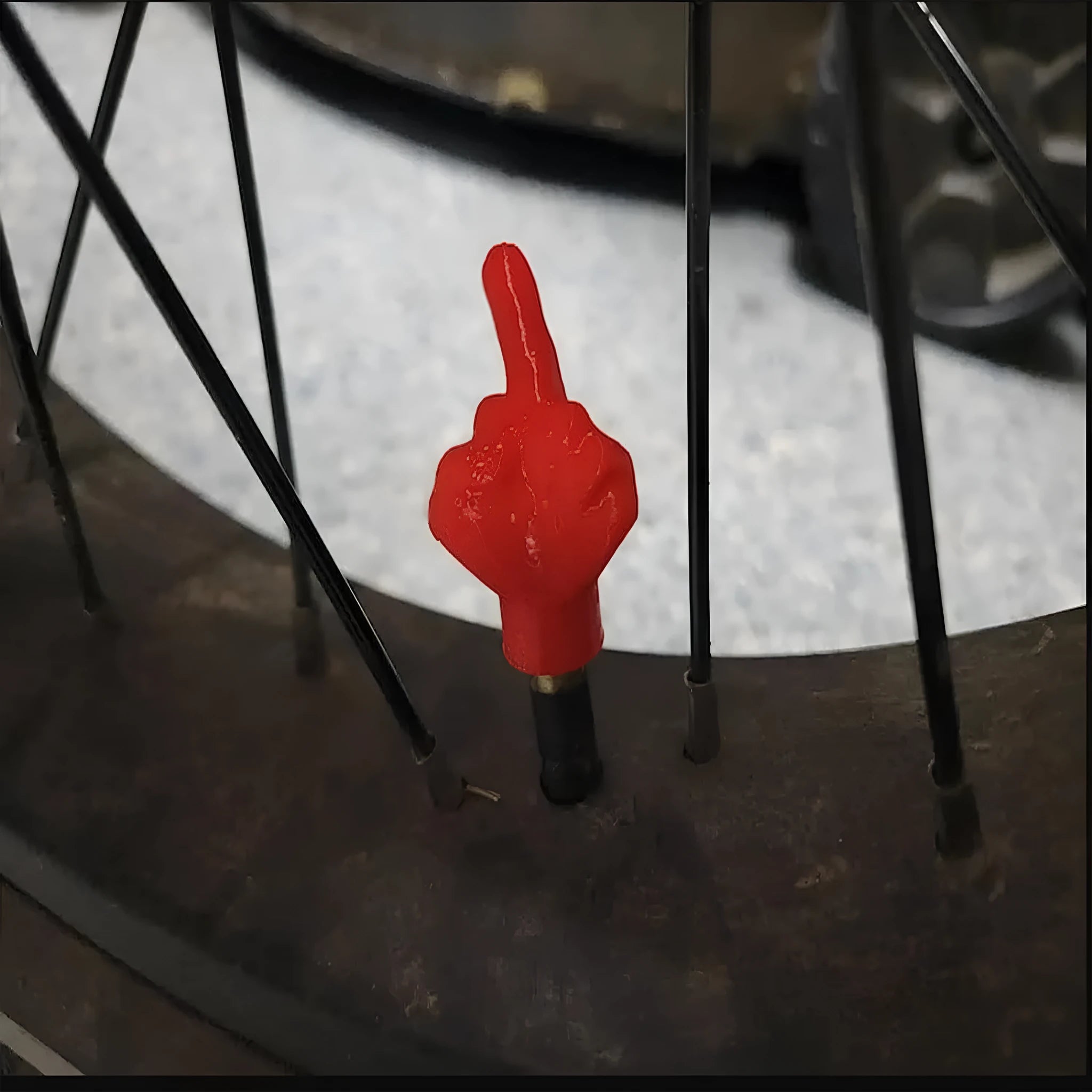 Four latex tyre valve dust caps, two black and two skin colour, for car tyre protection.