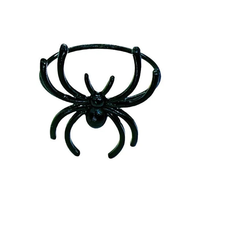 Set of six black metal spider-shaped napkin rings for Halloween table decorations.