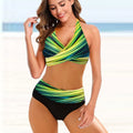 Women's striped tie-dye bikini set with hollow design and high-waisted briefs on a model.