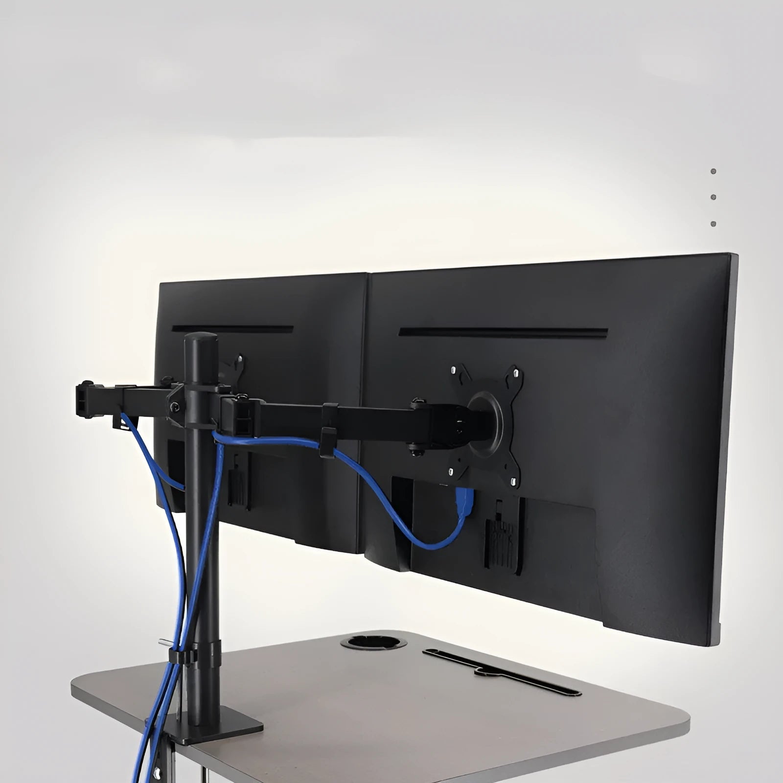 Steel computer monitor lifting bracket with rotating arm on a desk