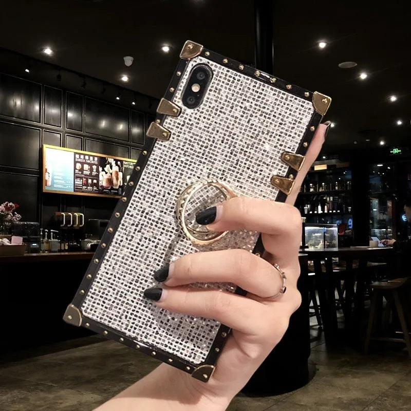 Square clear TPU mobile phone case with a silver flash diamond bracket on a smartphone.