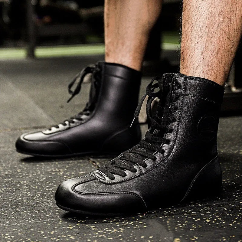 Professional black and gold mesh boxing shoes with non-slip soles for indoor training.