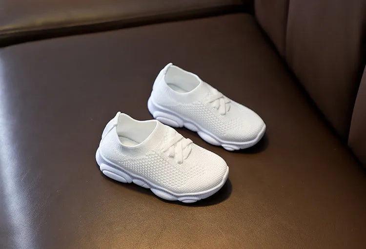 Children's lazy slip-on shoes in white, black, pink, or grey with fabric upper and rubber sole.