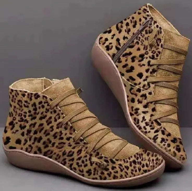 Women's casual flat booties with a wedge heel and round toe in a selection of colours including leopard print.