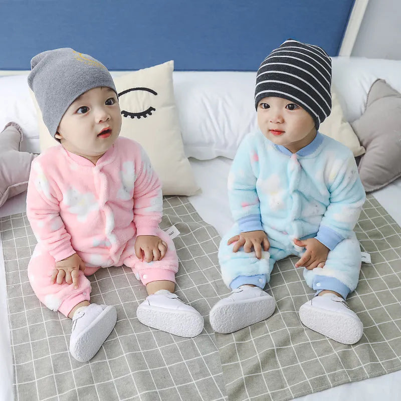 Baby wearing a long sleeve flannel romper in a panda or dinosaur print.
