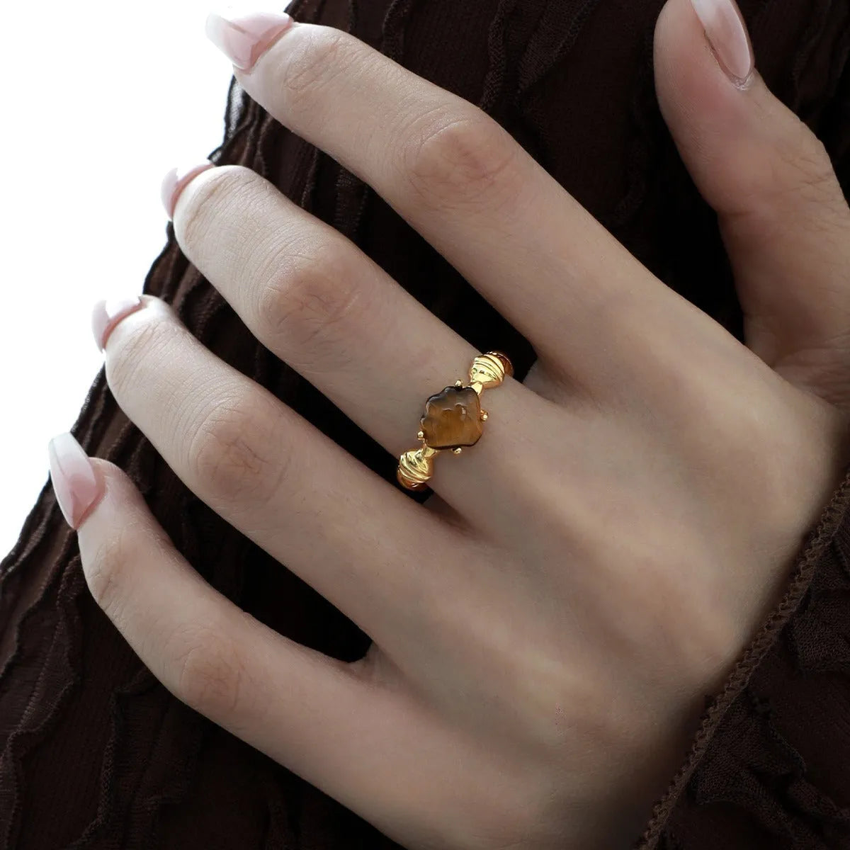 Silver adjustable ring with a white shell and tiger eye stone design in electroplated finish
