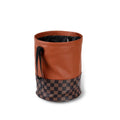 Brown leather folding interior trash can with a retractable handle, shown unfolded.
