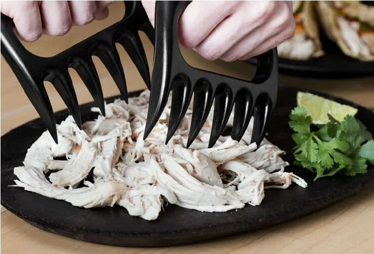 Two black plastic bear claw meat shredder forks for BBQ and kitchen use.