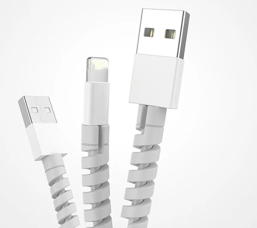 Plastic spiral charging cable protector in various colours next to a USB cable.