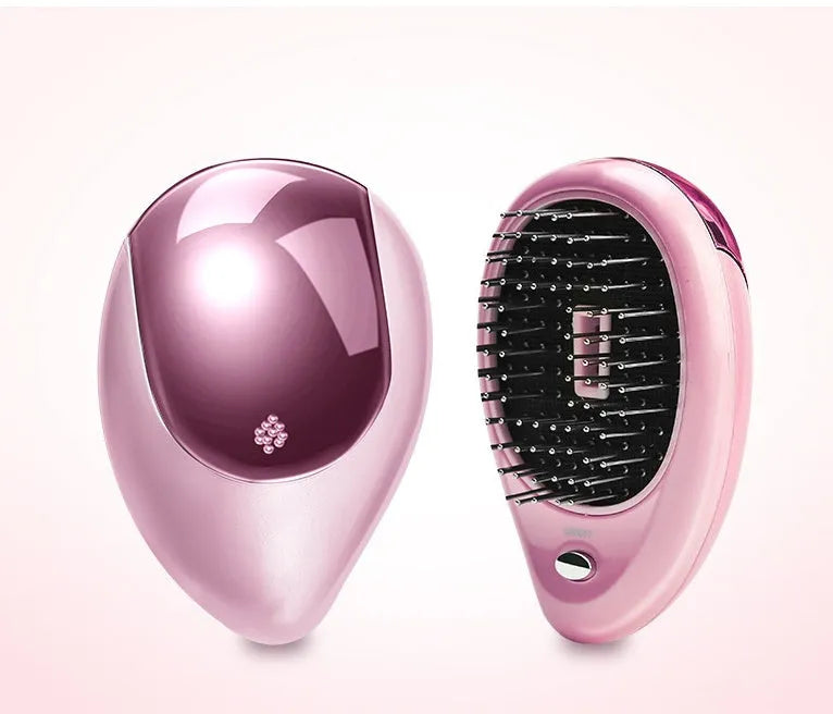 Pink electric ionic hair comb with ergonomic design on white background