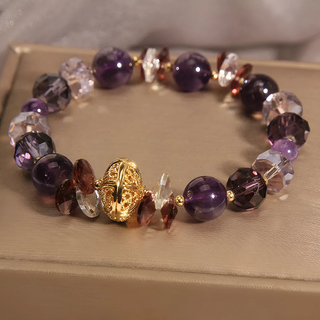 Purple crystal bracelet with pumpkin beads, wind chime motifs, and rhinestone decorations on adjustable band