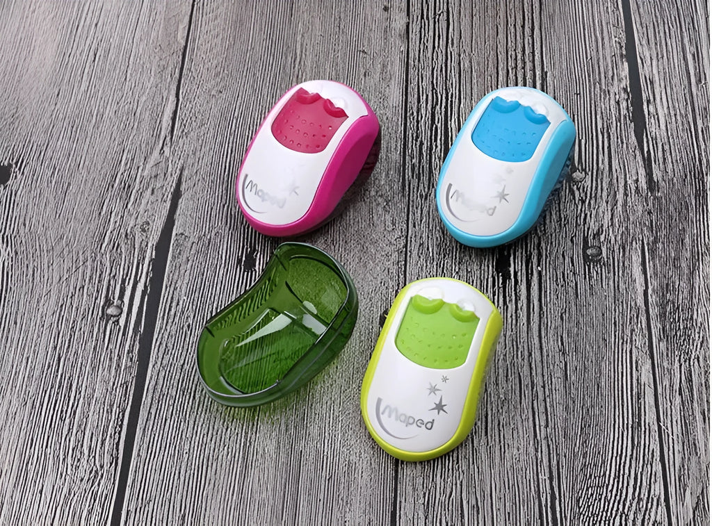 A single-hole plastic pencil sharpener in a random colour, showing its closed design.
