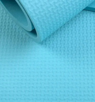 EVA fitness yoga mat in blue showing thickness and non-slip surface texture