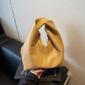 Women's casual dumpling-shaped PU leather handbag in multiple colours with internal organiser pockets.