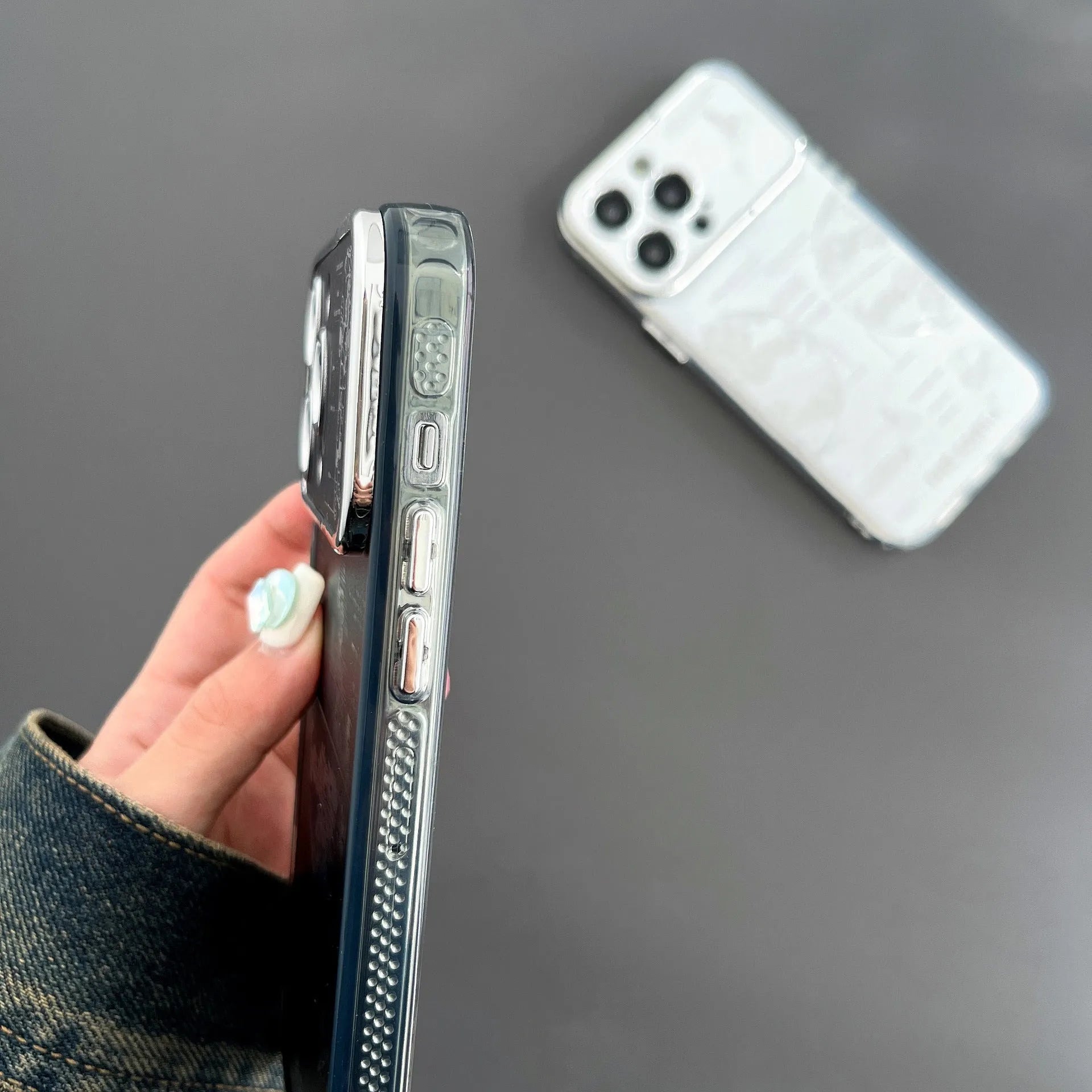Pleated bracket TPU phone case with metal planet design for iPhone 14 Pro, two colour options shown