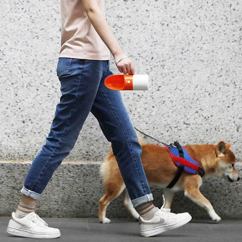 MOESTAR white and grey rocket-shaped pet drinking cup with a black drinking nozzle and lock button.