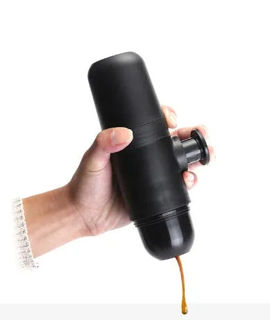 Black portable manual coffee machine showing compact 6x17.5cm design with stainless steel components