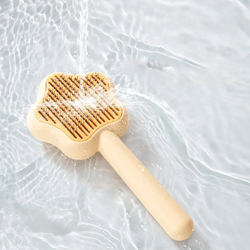 Green self-cleaning cat comb with four stainless steel needles measuring 20cm long
