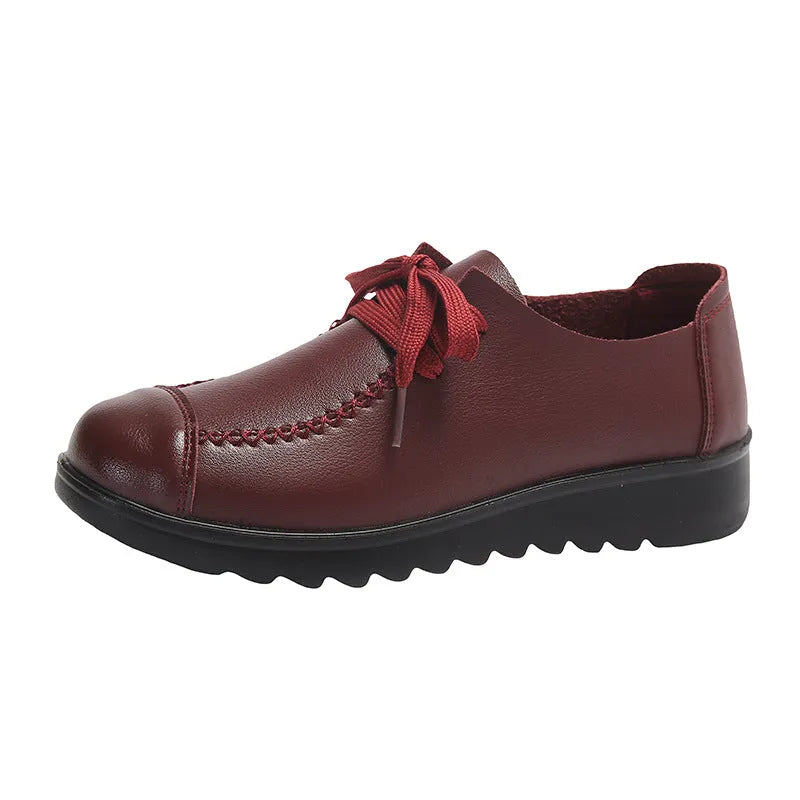 Women's black round toe flat work shoes with front lacing and soft anti-slip polyurethane sole