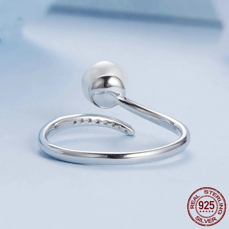 S925 sterling silver adjustable ring with shell pearl accents showing open loop design