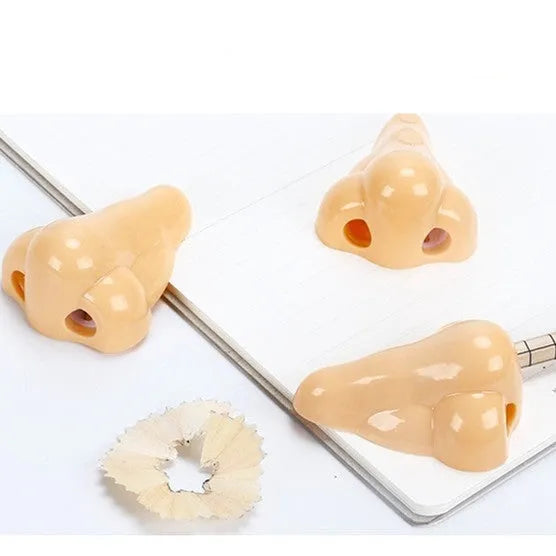 Flesh colour plastic manual pencil sharpener with geometry shape measuring 58x45x30mm