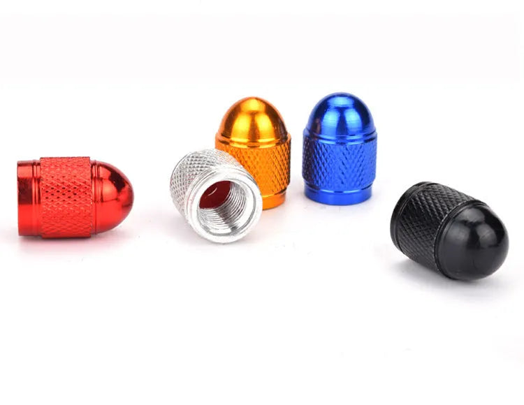 Aluminium mountain bike tyre valve caps in black, blue, gold, red, and silver colours.