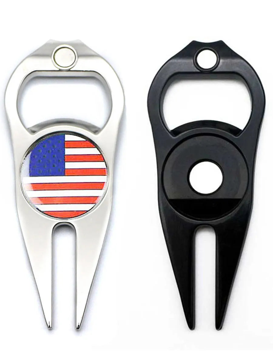 Black zinc alloy golf ball yoke bottle opener tool on a putting green.