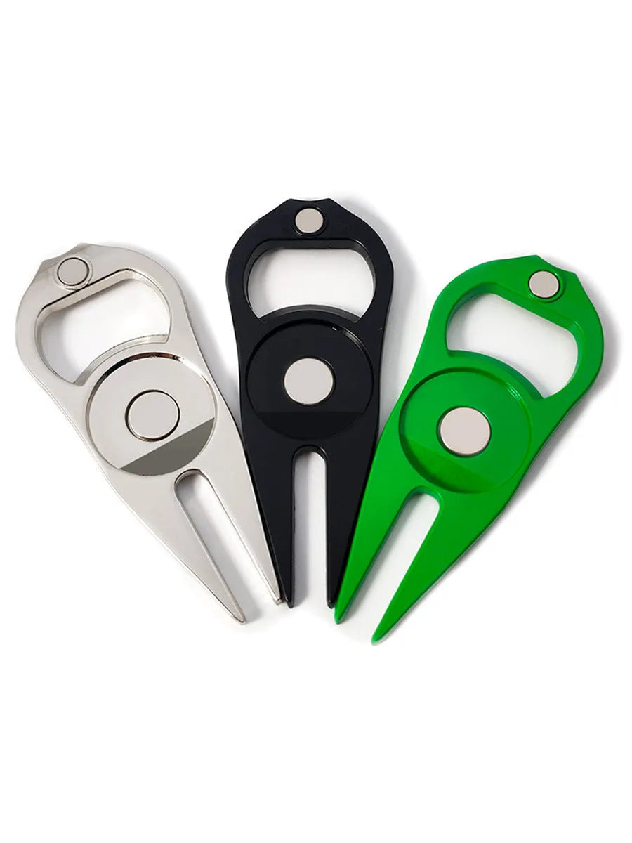 Black zinc alloy golf ball yoke bottle opener tool on a putting green.