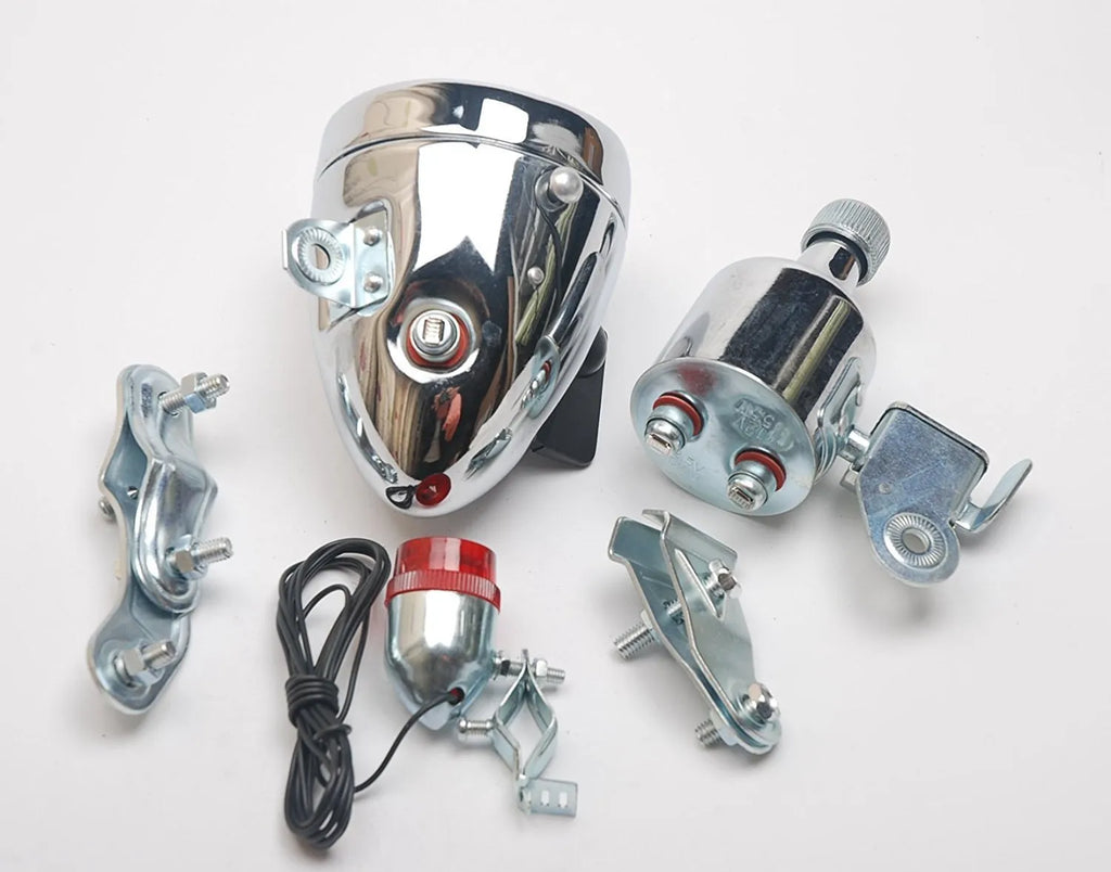 Silver bicycle dynamo generator light kit mounted on a bike frame for friction-powered 12V headlight and tail light
