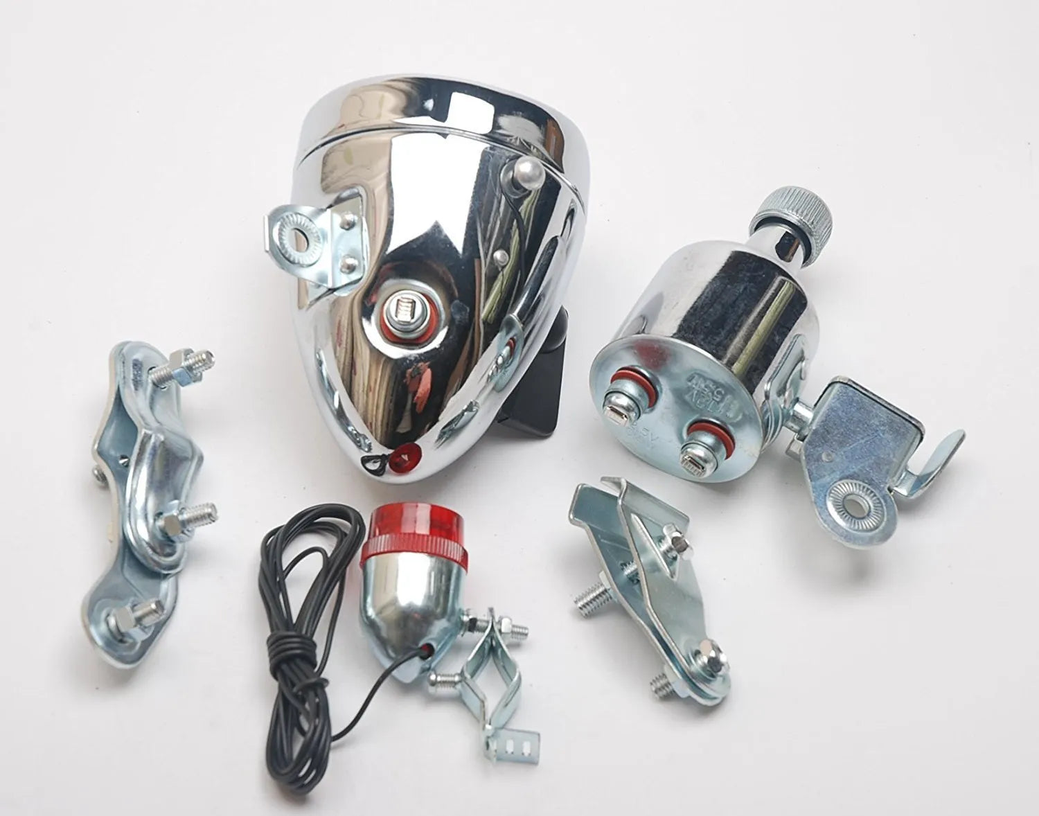 Silver bicycle dynamo generator light kit mounted on a bike frame for friction-powered 12V headlight and tail light