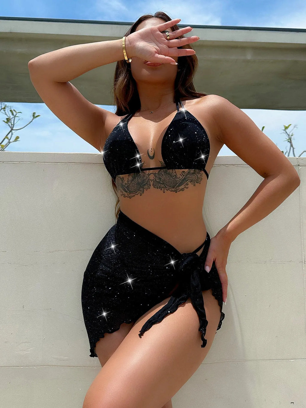 Black three-piece swimsuit bikini set with matching shorts on a mannequin