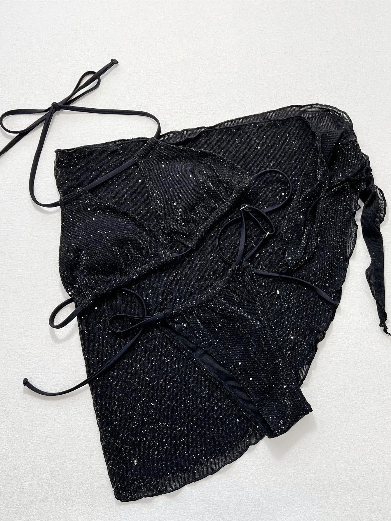Black three-piece swimsuit bikini set with matching shorts on a mannequin