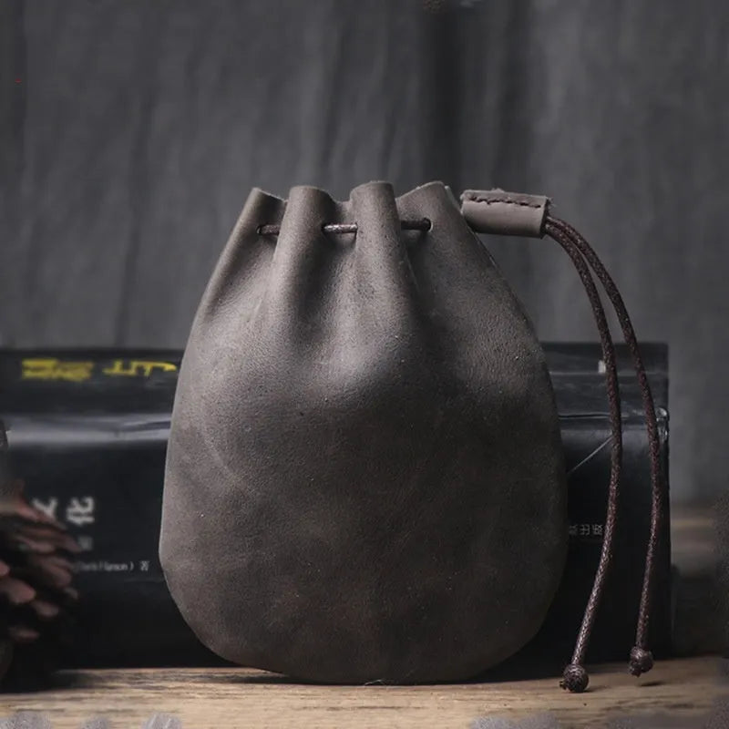 Vintage cowhide drawstring bundle wallet in genuine leather showing drawstring closure and sewing thread details