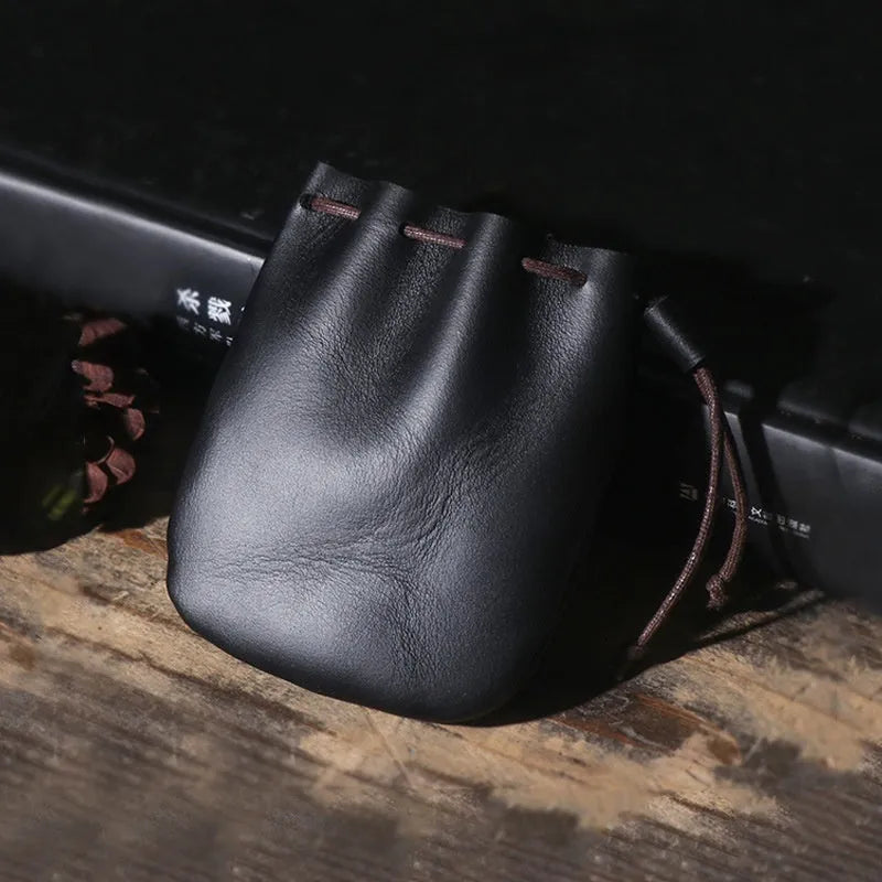 Vintage cowhide drawstring bundle wallet in genuine leather showing drawstring closure and sewing thread details