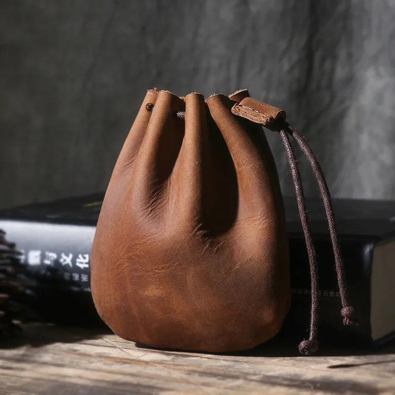 Vintage cowhide drawstring bundle wallet in genuine leather showing drawstring closure and sewing thread details