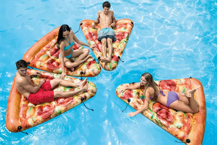 Large green and beige pizza-themed inflatable surfboard lounger floating on water